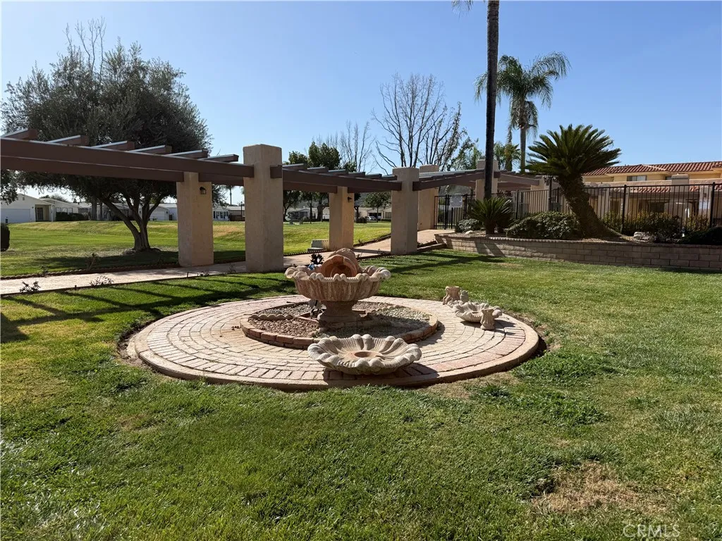 27250 Murrieta Road, Unit 51 Menifee, CA 92586 - Photo 14 of 15 a swimming pool with barbeque oven outdoor seating and yard