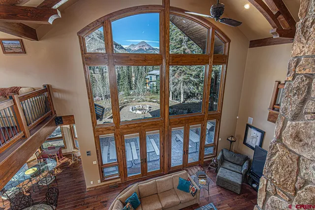 a living room with furniture and a floor to ceiling window