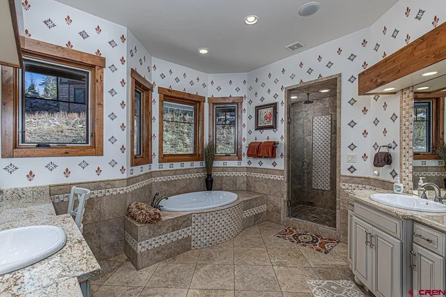 a spacious bathroom with a granite countertop tub sink and mirror