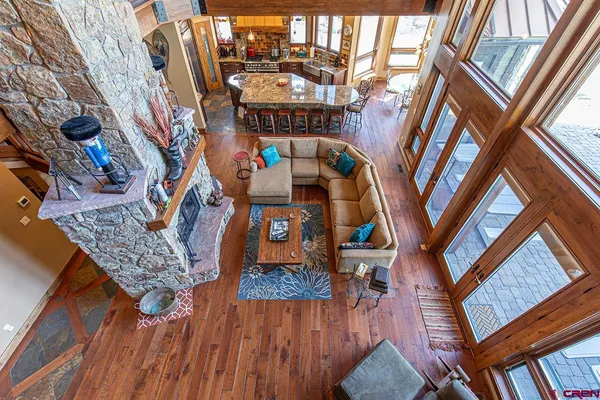 a very nice looking living room with furniture and floor to ceiling windows