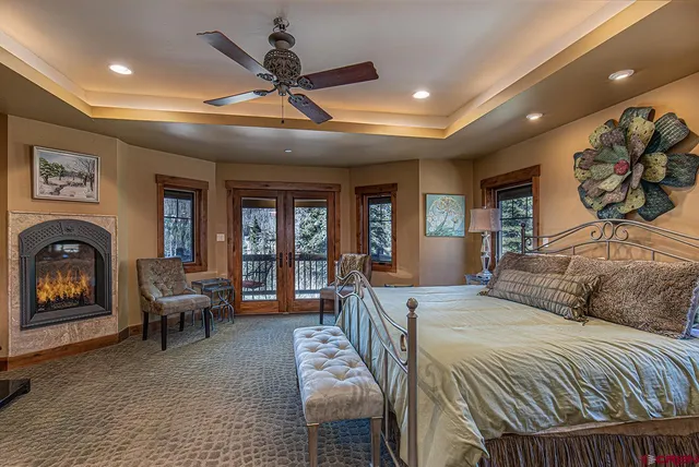 a bedroom with a bed and ceiling fan
