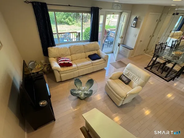 a living room with furniture and a floor to ceiling window
