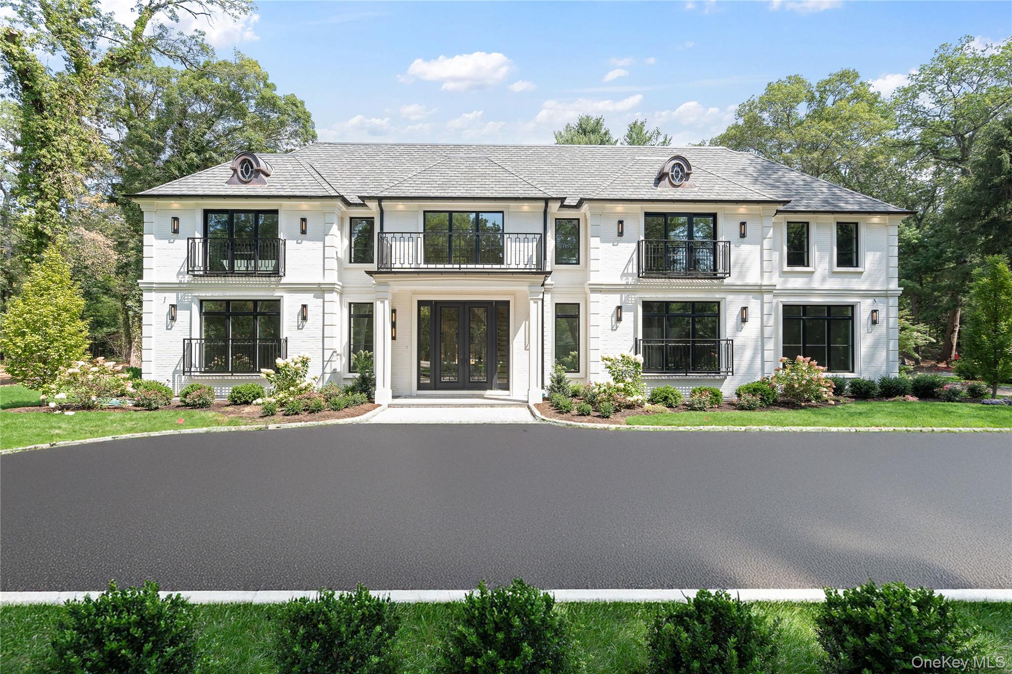 French provincial home with a balcony and french doors
