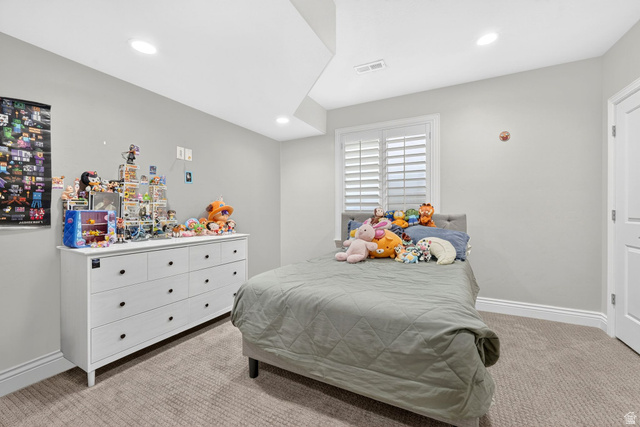 14738 Tangle Hill Road Herriman, UT 84096 - Photo 45 of 66 Carpeted room featuring a window with plantation shutters, recessed lighting, and a neutral wall color