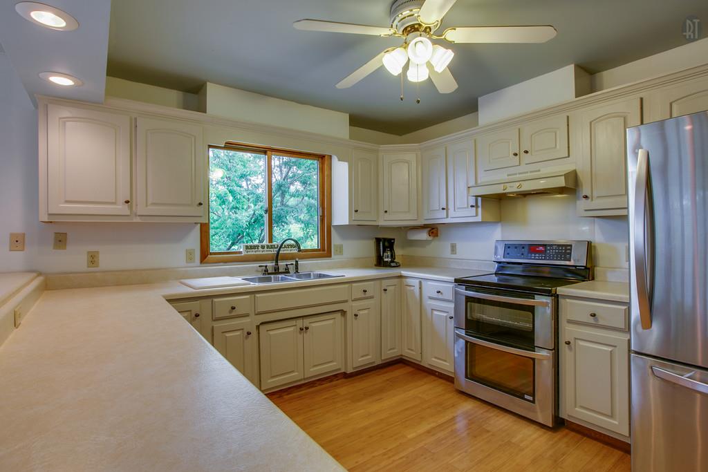 893 Floating Mill Village Road Silver Point, TN 38582 - Photo 6 of 23 a kitchen with stainless steel appliances granite countertop a sink stove and refrigerator