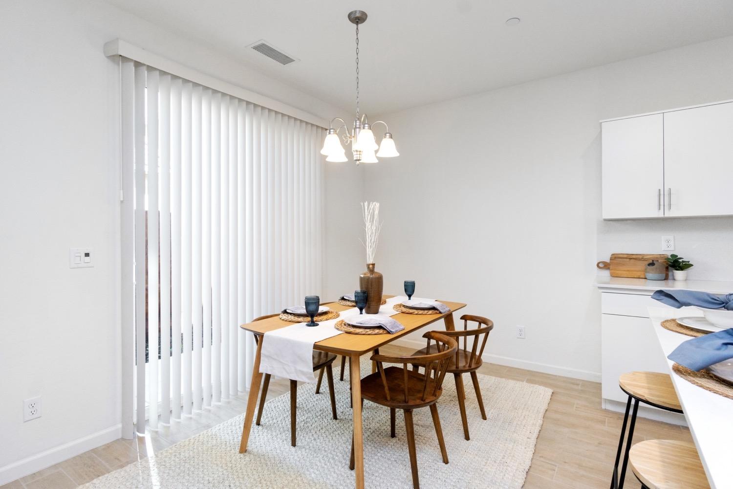 3759 Highpark Way Clovis, CA 93619 - Photo 11 of 32 a view of a dining room with furniture and chandelier
