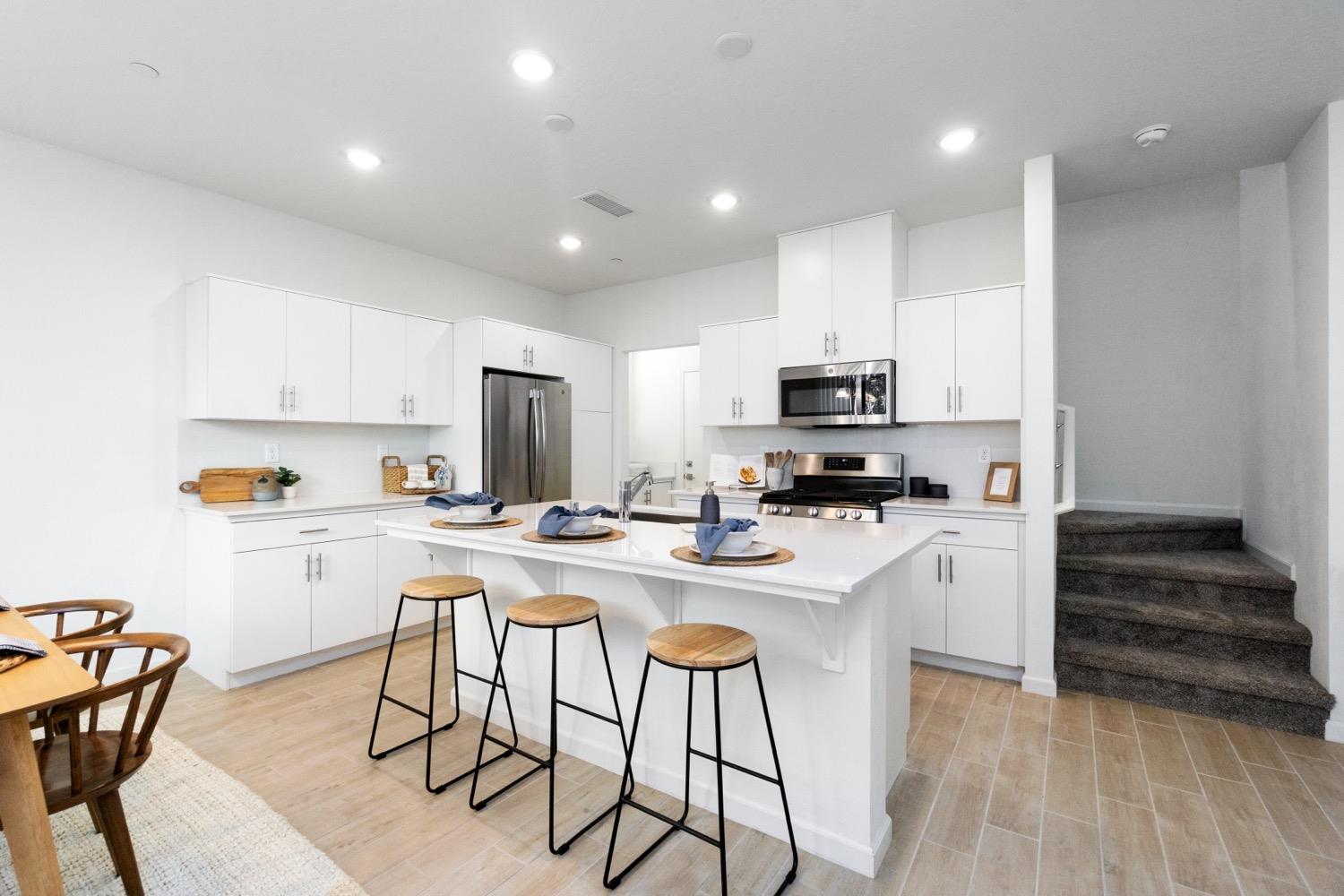 3759 Highpark Way Clovis, CA 93619 - Photo 12 of 32 a kitchen with a sink a counter top space appliances and cabinets