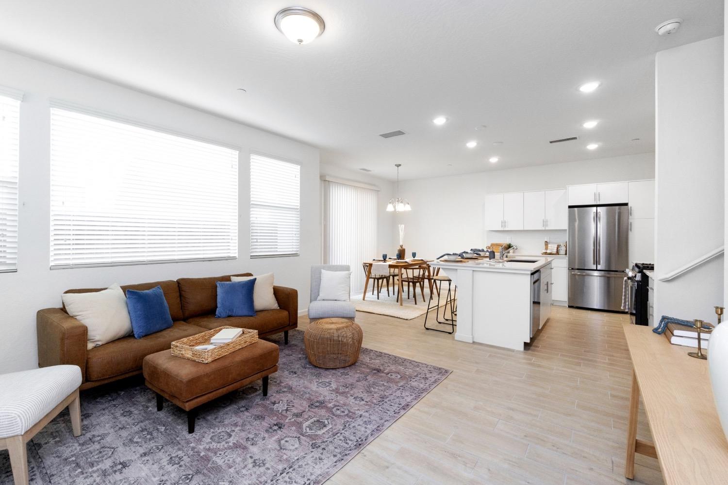 3759 Highpark Way Clovis, CA 93619 - Photo 7 of 32 a living room with furniture a refrigerator and kitchen view