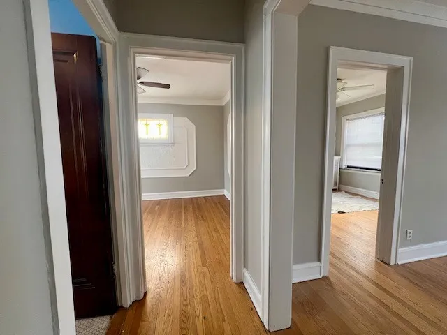 a view of a hallway with wooden floor