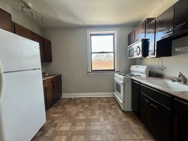 a kitchen with a sink stove and refrigerator