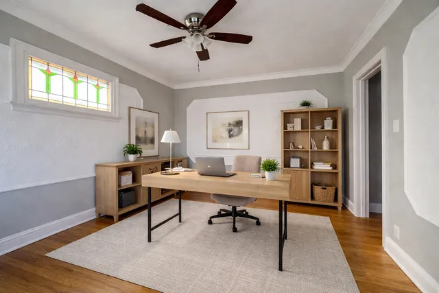 a view of a workspace with furniture and a window
