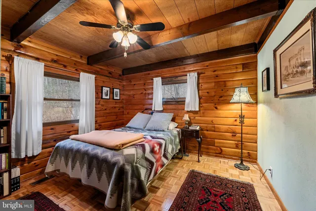 a bed sitting in a bedroom next to a window