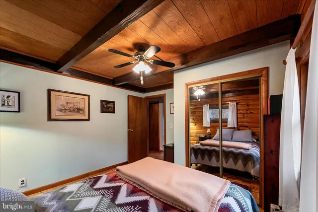 a bedroom with bed and a chandelier