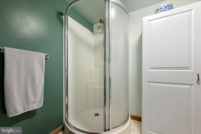 a living room with furniture and a painting on the wall