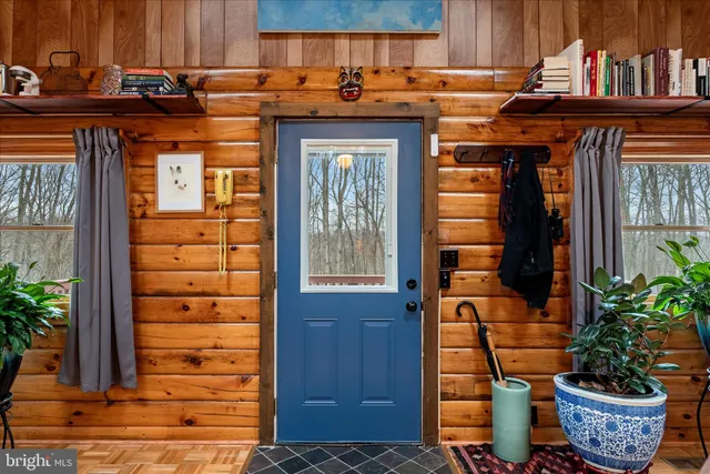 a front view of a house with potted plants