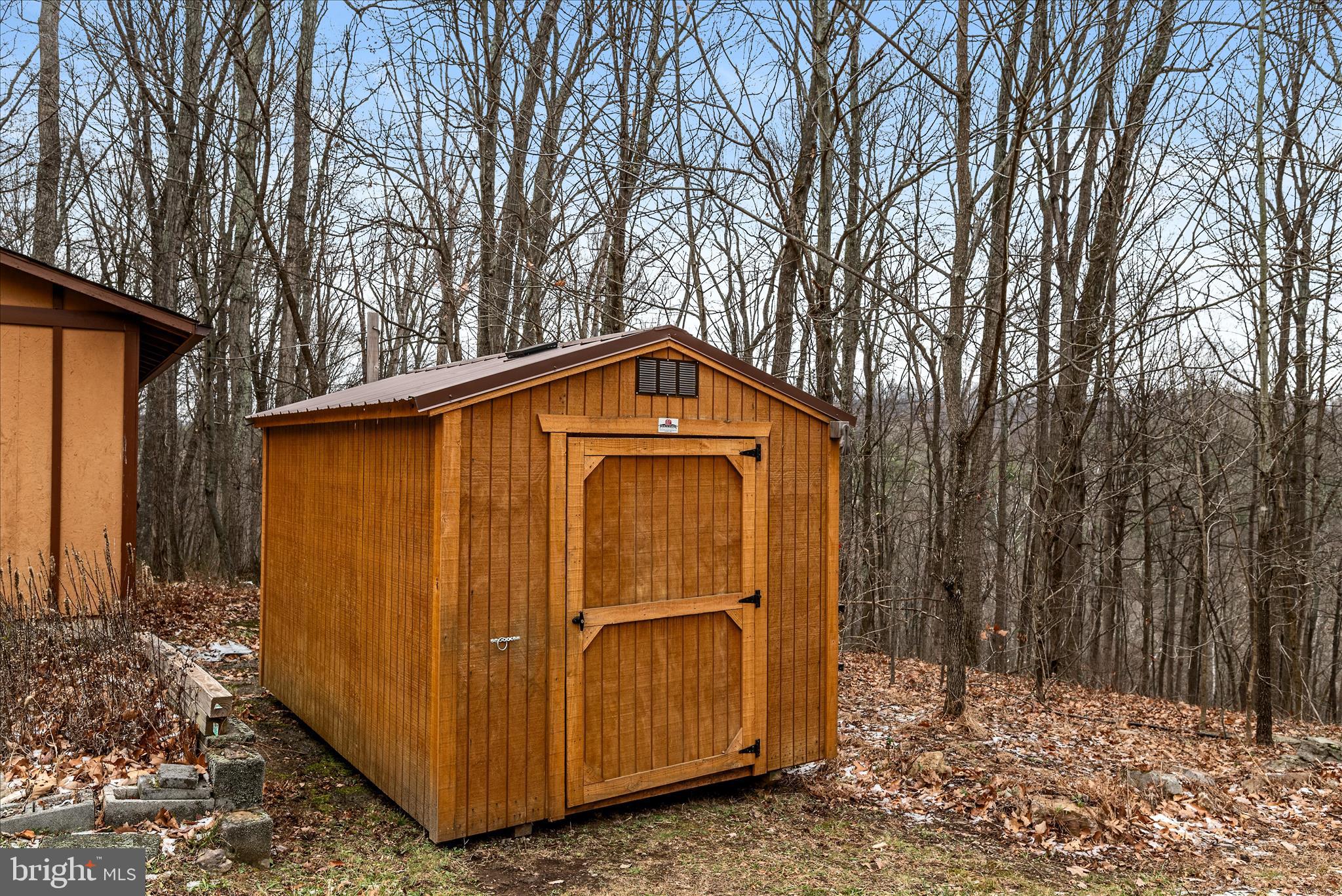 249 Crestview Lane Berkeley Springs, WV 25411 - Photo 43 of 52 a view of a house with a large tree and wooden fence