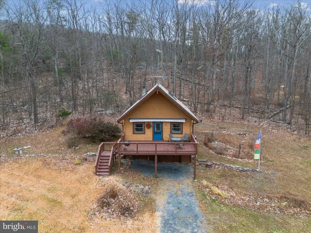 a wooden bench sitting in middle of a field