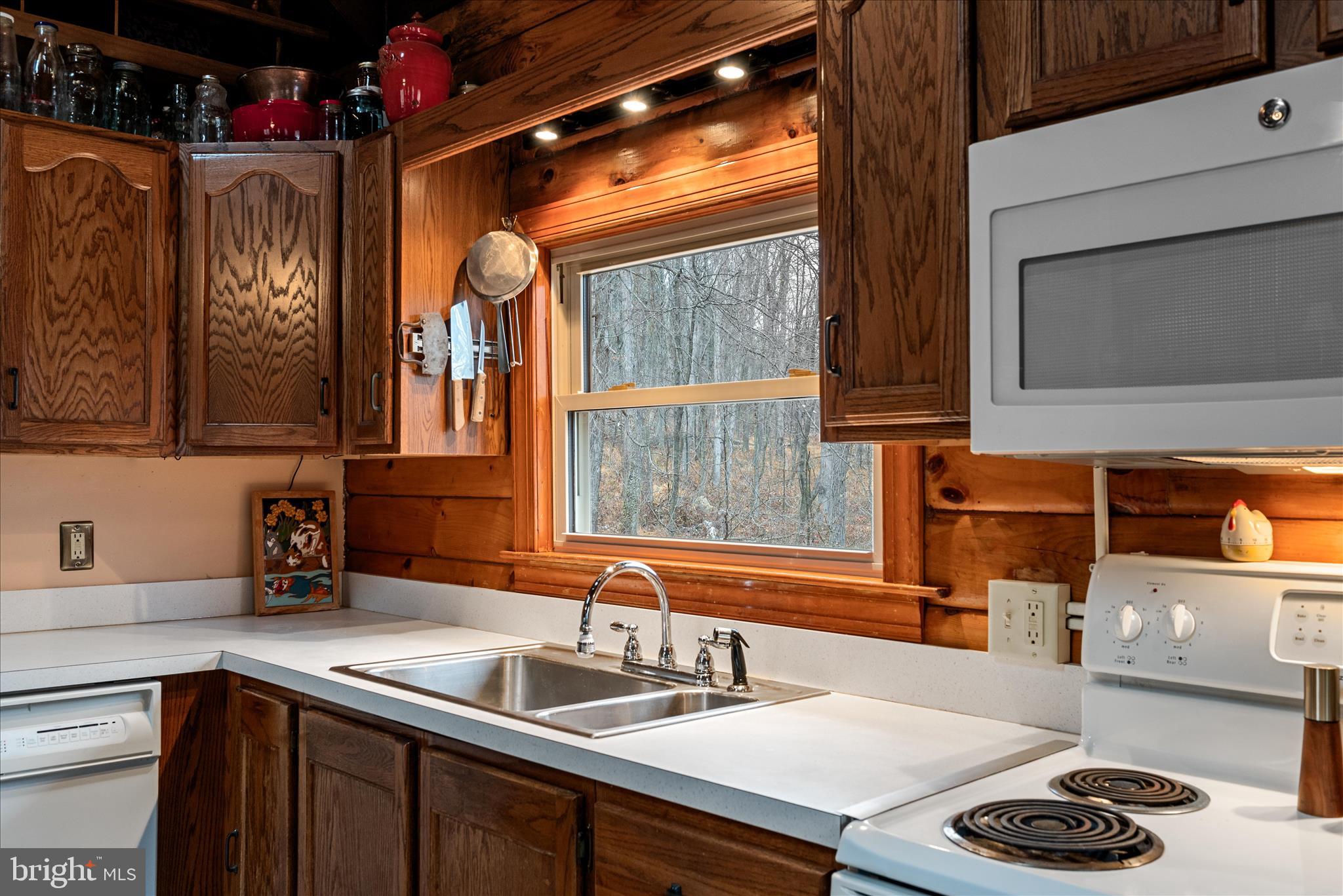 249 Crestview Lane Berkeley Springs, WV 25411 - Photo 6 of 52 a kitchen with a sink and a stove next to a window