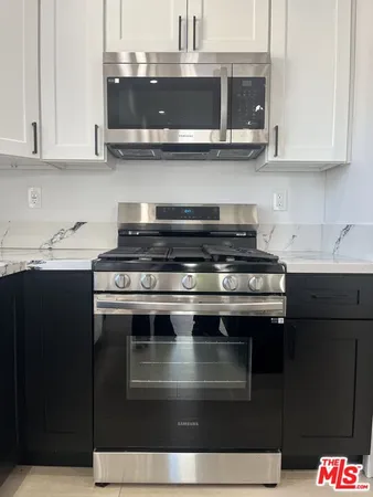 a stove top oven sitting inside of a kitchen