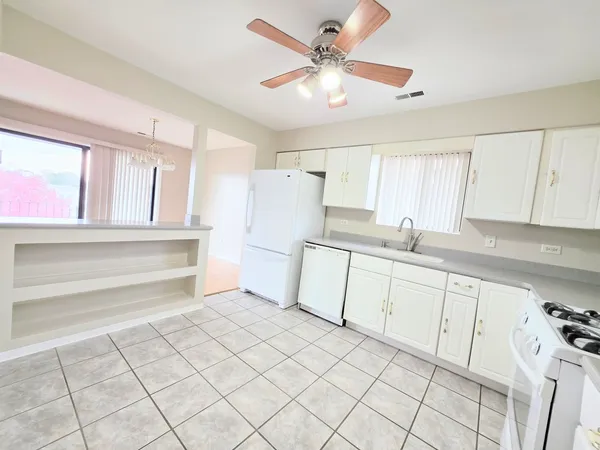 a kitchen with granite countertop cabinets and white appliances