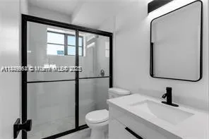 a bathroom with a sink toilet and a mirror