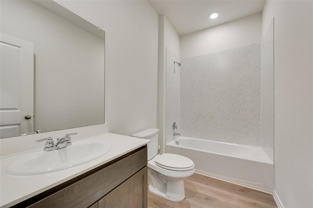 1428 Millstead Rill Drive Caddo Mills, TX 75135 - Photo 11 of 24 a bathroom with a granite countertop sink a toilet and shower
