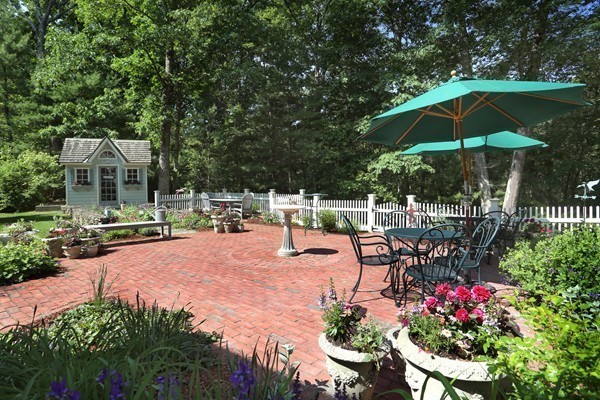 65 Boren Lane Boxford, MA 01921 - Photo 3 of 28 a view of a patio with a table and chairs under an umbrella