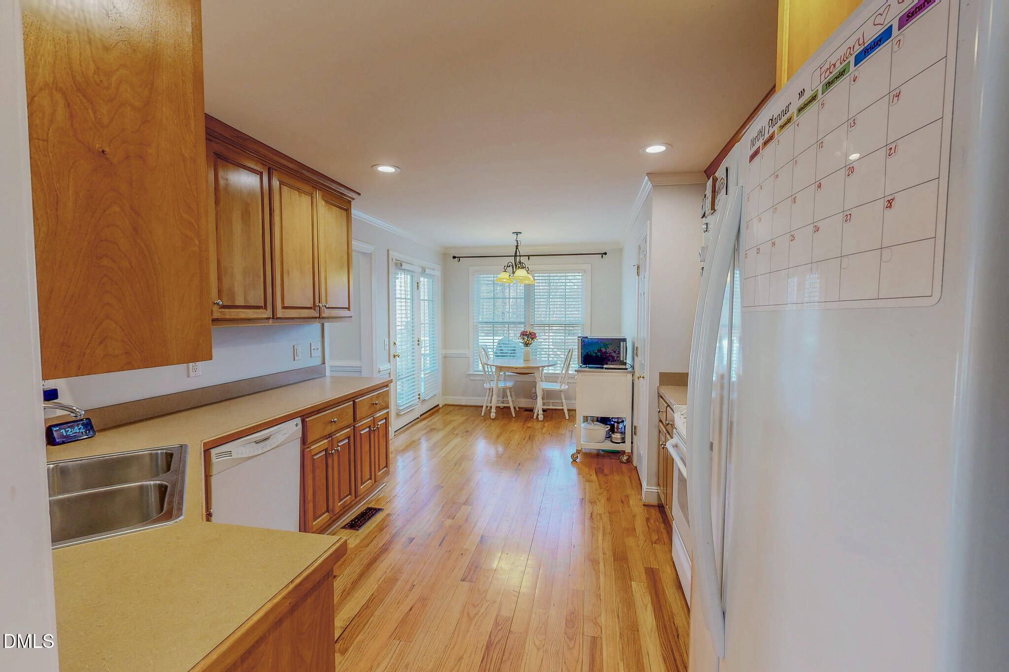 70 Younger Road Roxboro, NC 27573 - Photo 20 of 45 a kitchen with stainless steel appliances a refrigerator a sink dishwasher and wooden cabinets with wooden floor