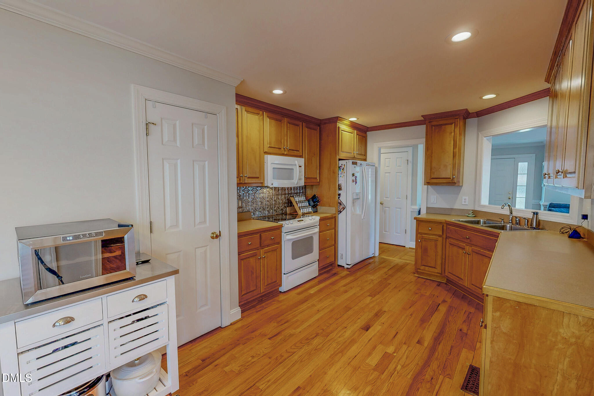 70 Younger Road Roxboro, NC 27573 - Photo 40 of 45 a large kitchen with a center island wooden floor and stainless steel appliances