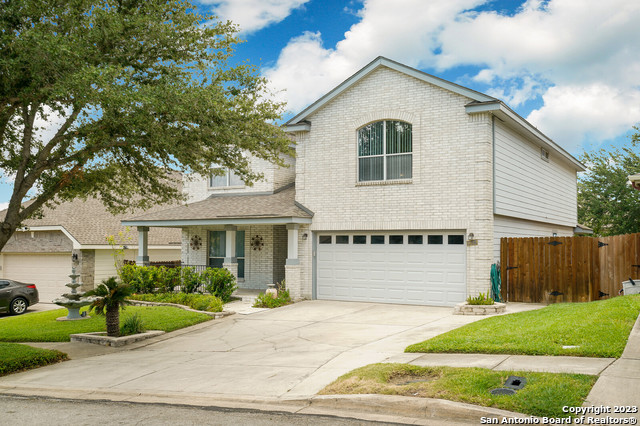 a view of a white house with a large windows next to a yard