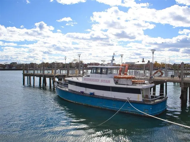 a view of a roof deck with two couches and wooden floor