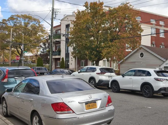 a view of a cars park in front of a building
