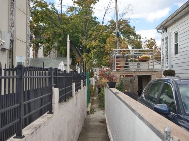 a view of a balcony and yard with wooden fence