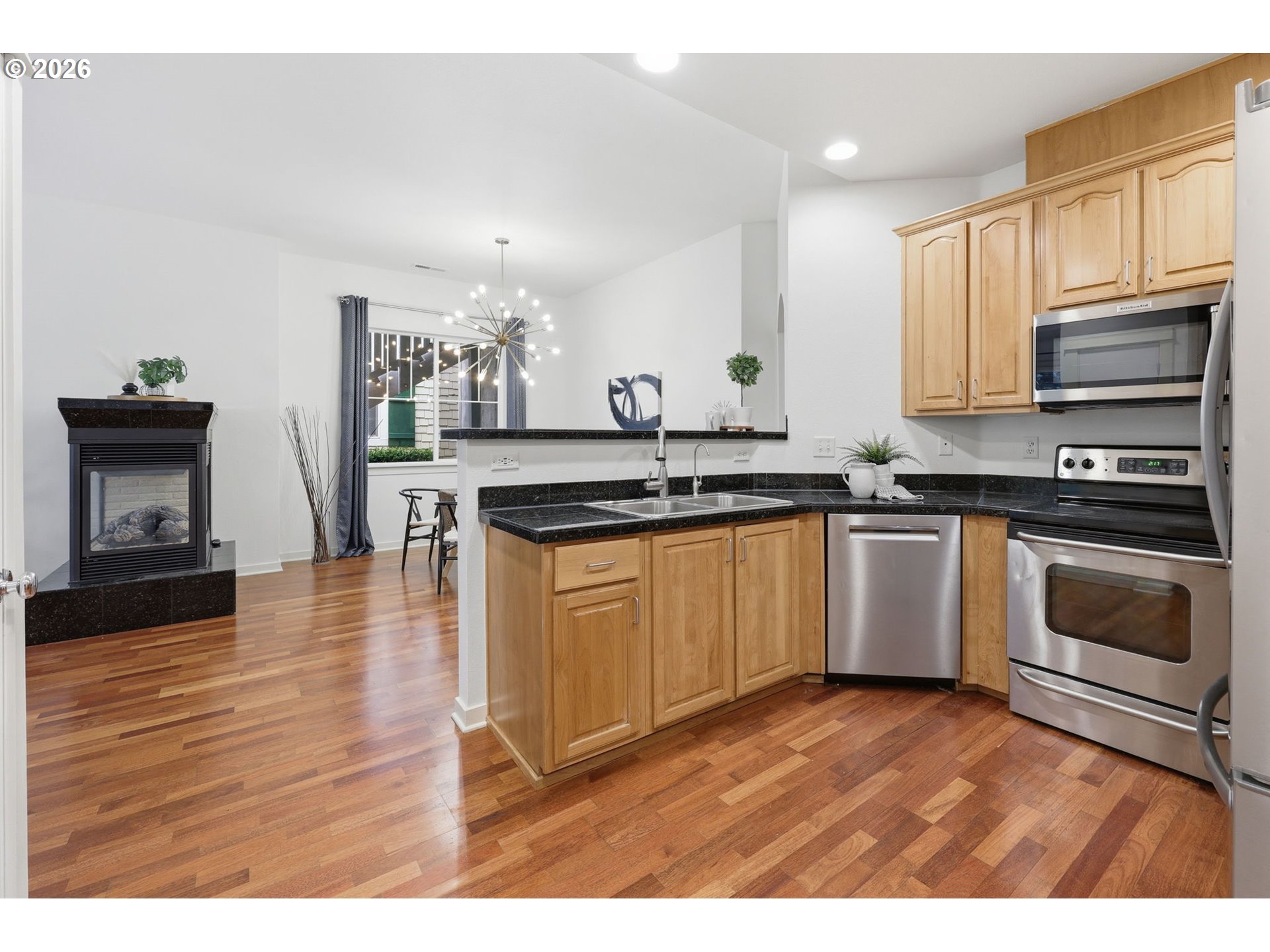 8361 Southwest 24th Avenue Portland, OR 97219 - Photo 14 of 39 a kitchen with stainless steel appliances granite countertop a stove a sink and a microwave