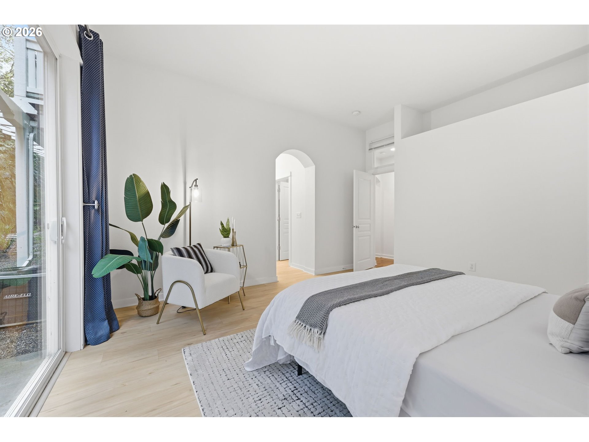 8361 Southwest 24th Avenue Portland, OR 97219 - Photo 18 of 39 a bedroom with a bed and chandelier