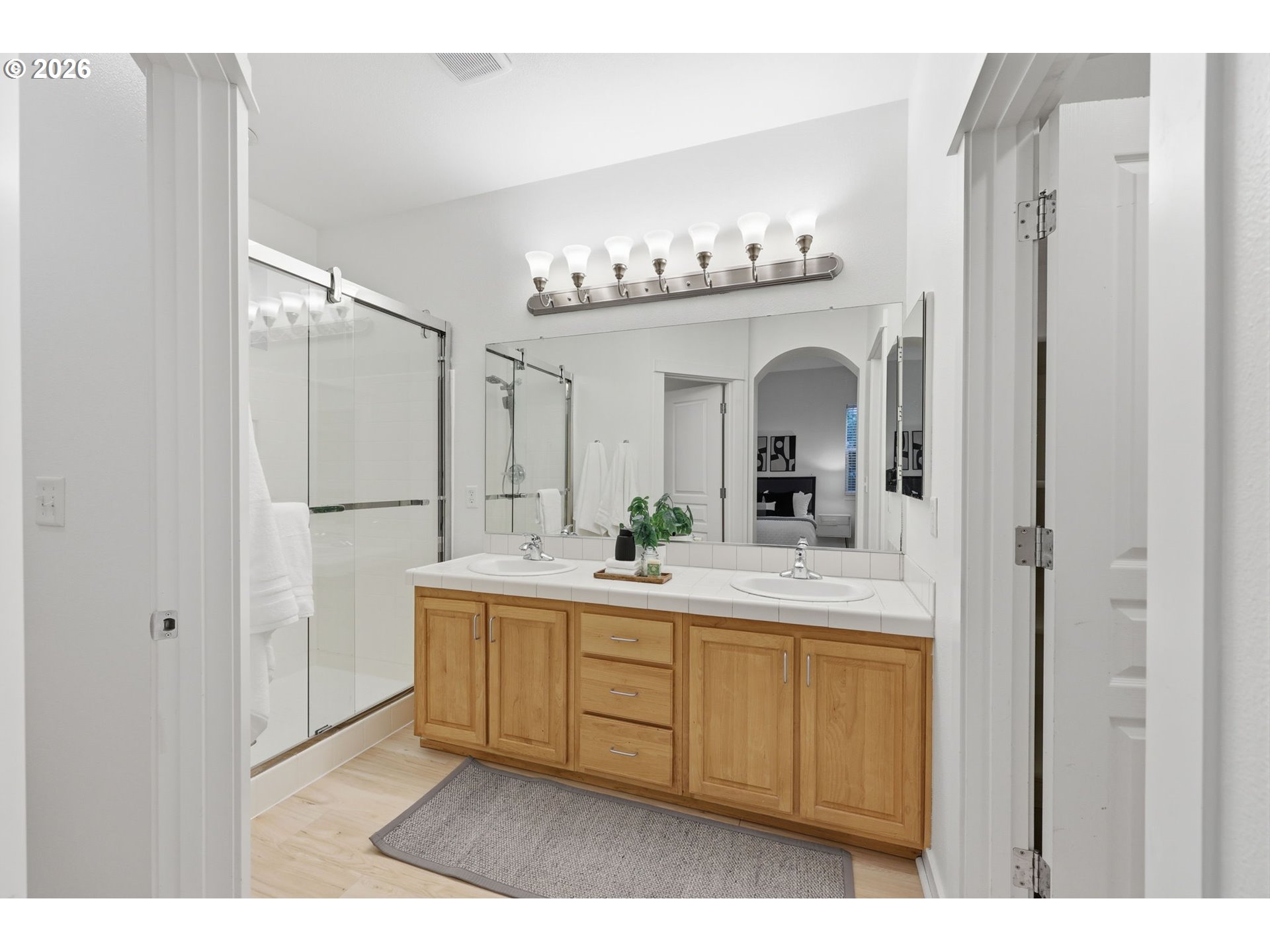 8361 Southwest 24th Avenue Portland, OR 97219 - Photo 19 of 39 a view of a bathroom with a sink mirror and a bath tub