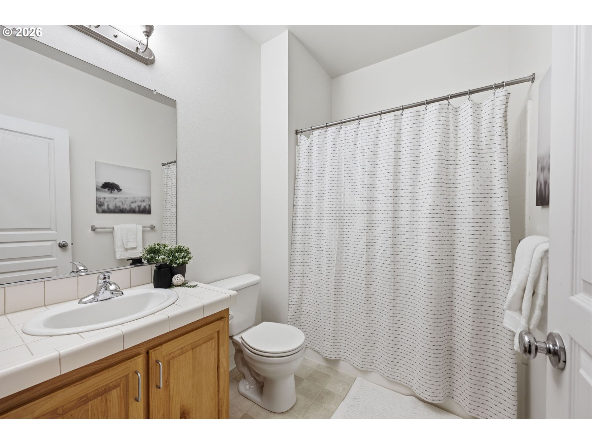 8361 Southwest 24th Avenue Portland, OR 97219 - Photo 26 of 39 a bathroom with a granite countertop sink toilet and a mirror