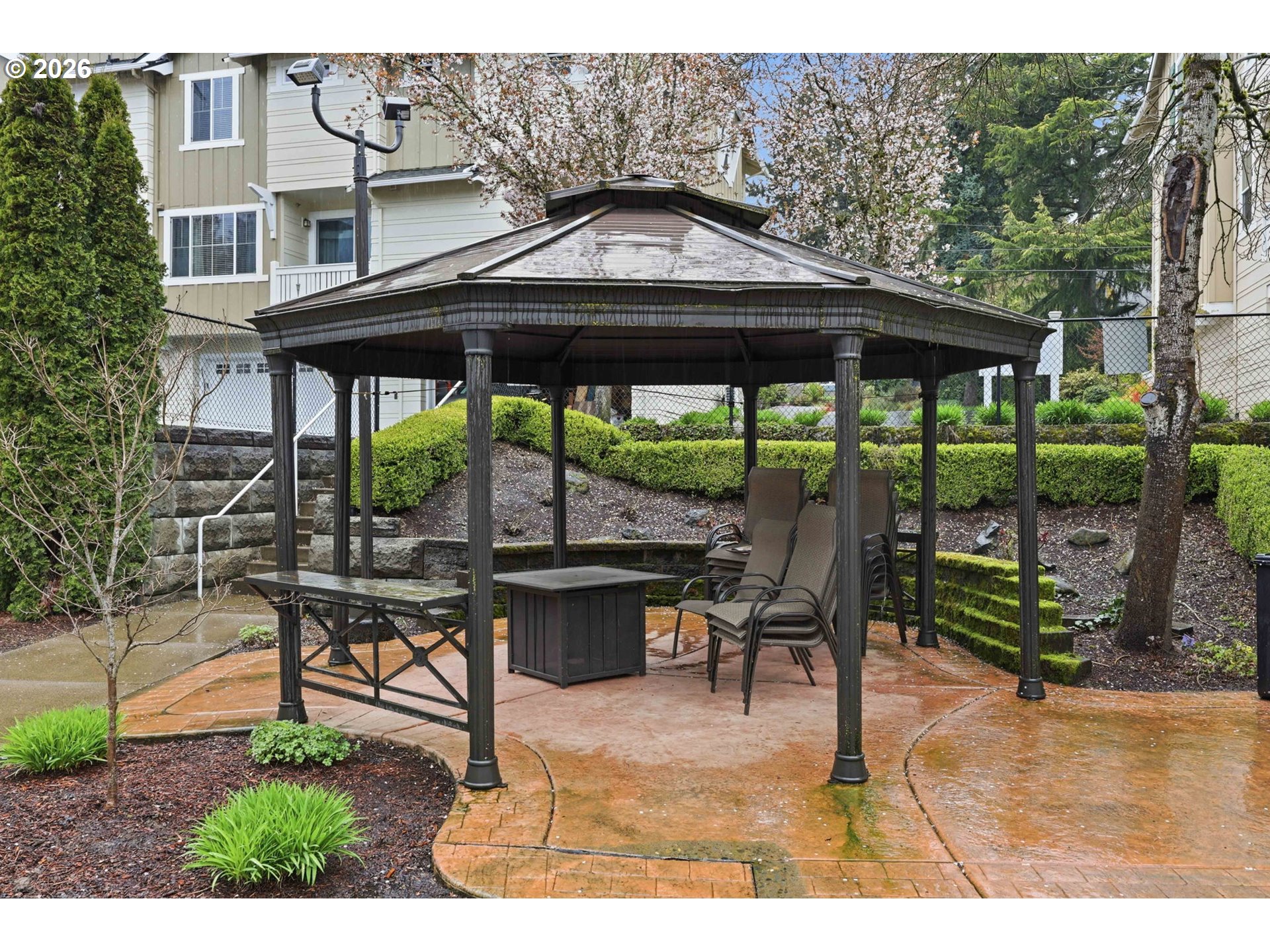 8361 Southwest 24th Avenue Portland, OR 97219 - Photo 36 of 39 a backyard of a house with table and chairs