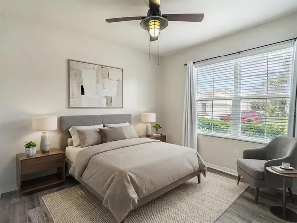a bedroom with a bed a couch and a window