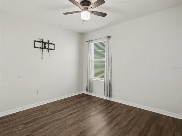 a view of a room with wooden floor and windows