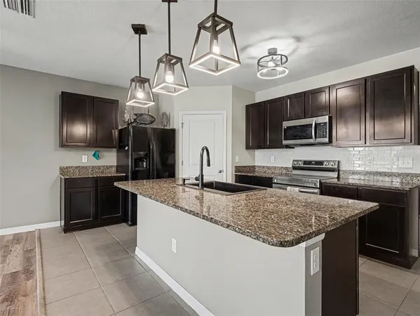 a kitchen with a sink and microwave