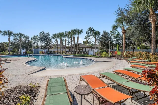 swimming pool view with a seating space