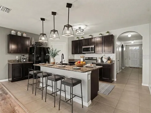 a kitchen with sink cabinets and stainless steel appliances