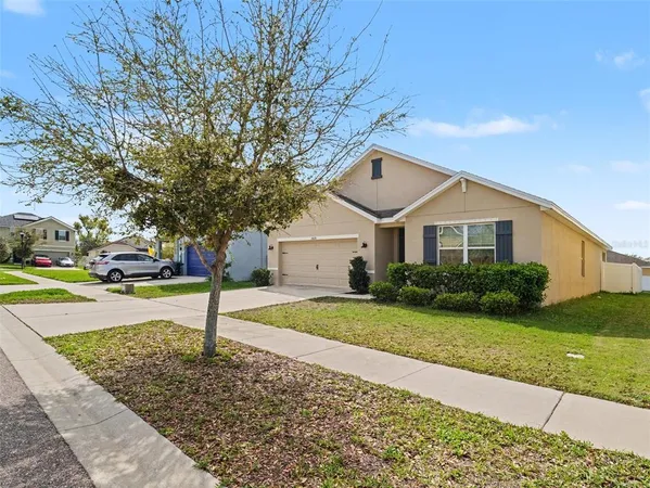 a front view of a house with a garden and yard
