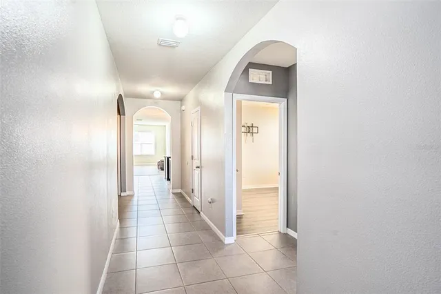 a view of a hallway to a livingroom with wooden floor