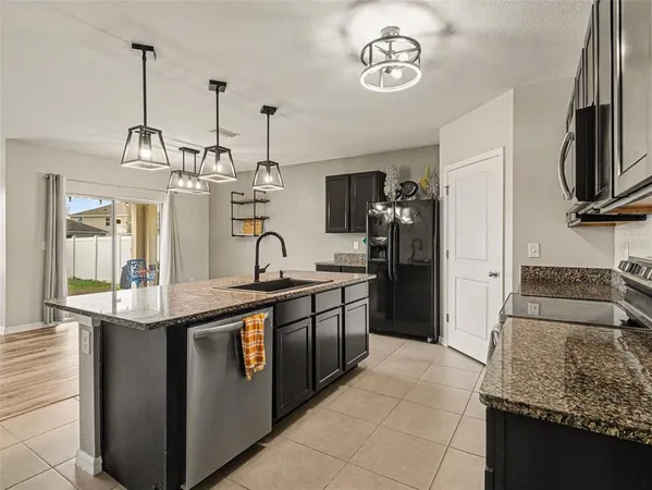 a kitchen with stainless steel appliances granite countertop a sink and stove