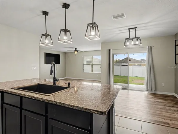 a kitchen with kitchen island a sink and wooden floor