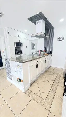a kitchen with stainless steel appliances a sink and a refrigerator