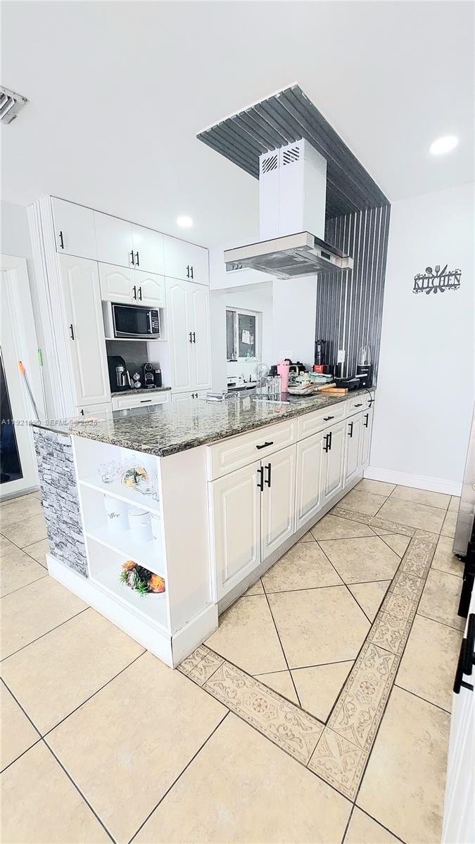 2145 Southwest 76th Avenue Miami, FL 33155 - Photo 12 of 28 a kitchen with stainless steel appliances a sink and a refrigerator
