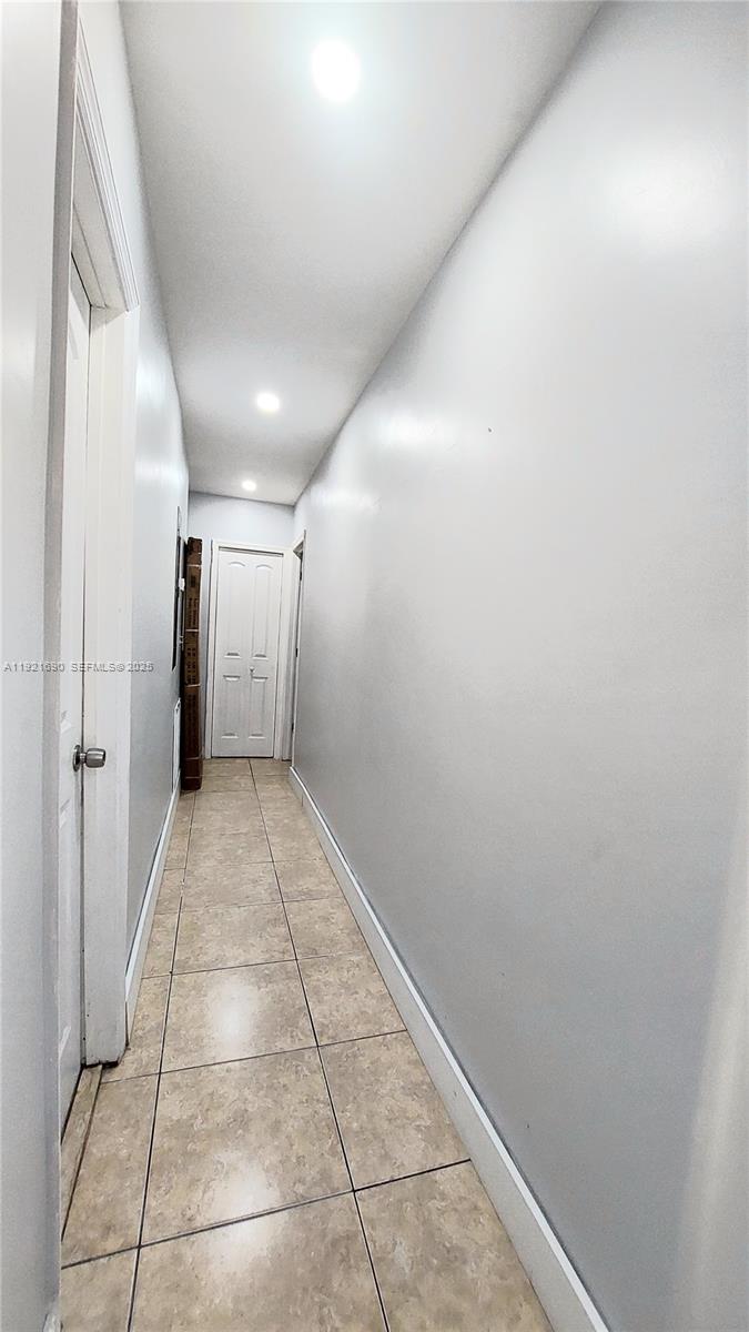 2145 Southwest 76th Avenue Miami, FL 33155 - Photo 13 of 28 a view of hallway with a window and a refrigerator